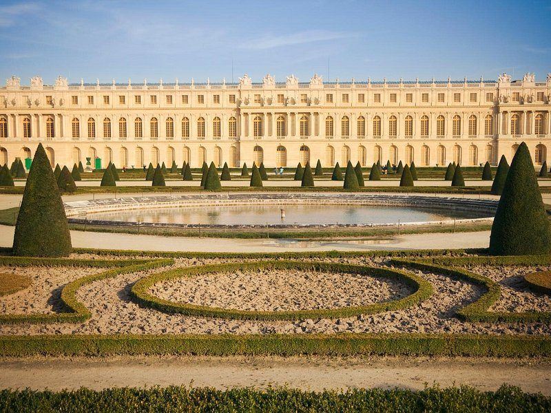 The garden front of the Palace of Versailles above clipped parterres